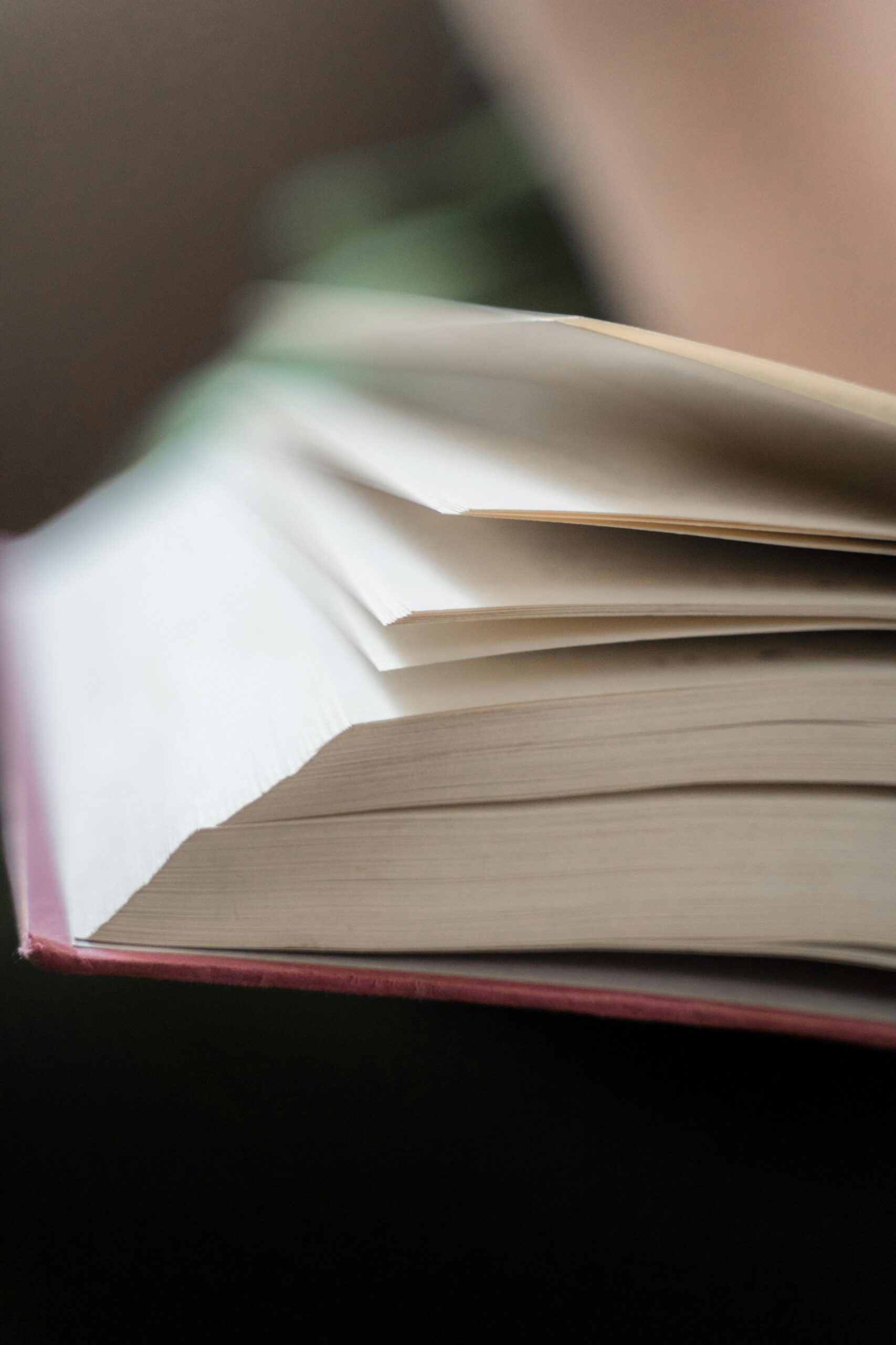 Close-up of an open novel with visible pages, representing the debut novel ‘Becoming Real.’