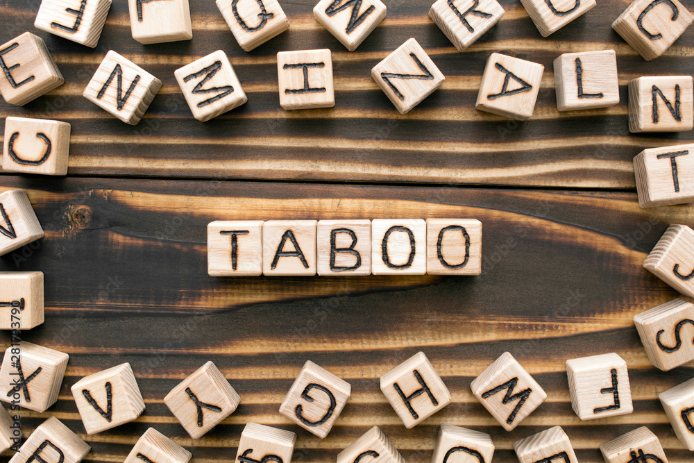 Scrabble blocks on a wooden table spelling the word ‘taboo,’ symbolizing the discussion of taboo topics in copywriting.