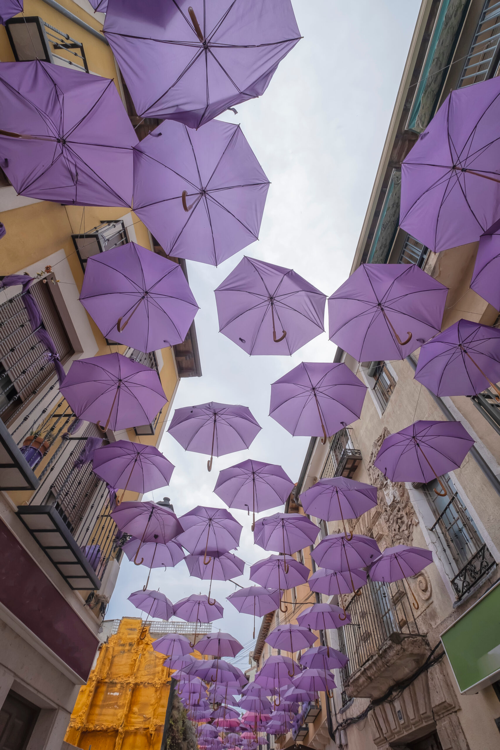 Colorful umbrellas floating in the sky in Spain, used to represent the brainstorming process on my website.